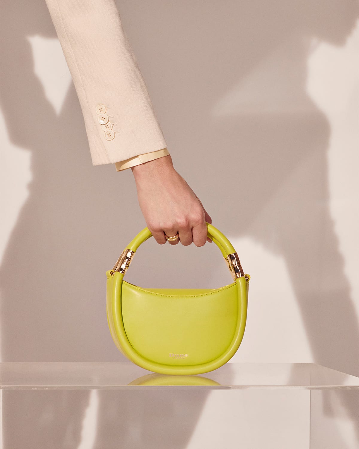 Model holding the Dune London Daphny grab bag in lime green