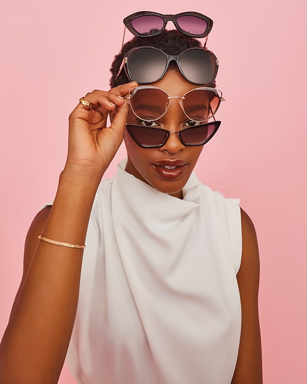 Model with multiple Dune London sunglasses on her face