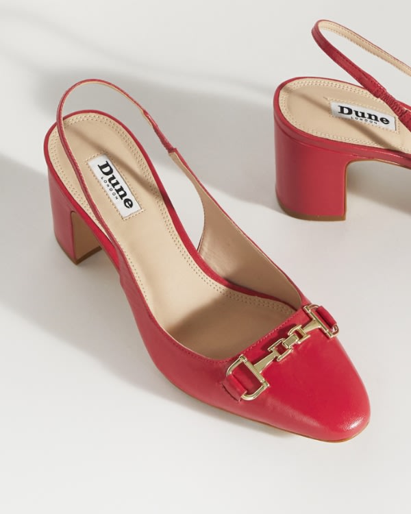 Women's red sling back court shoe with block heel and gold snaffle detail