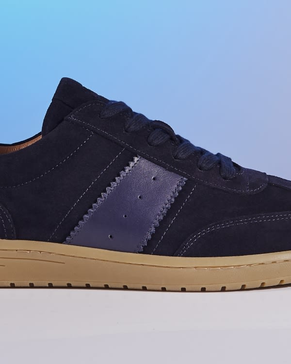 Men's trainer crafted from suede and accented with contrasting panels
