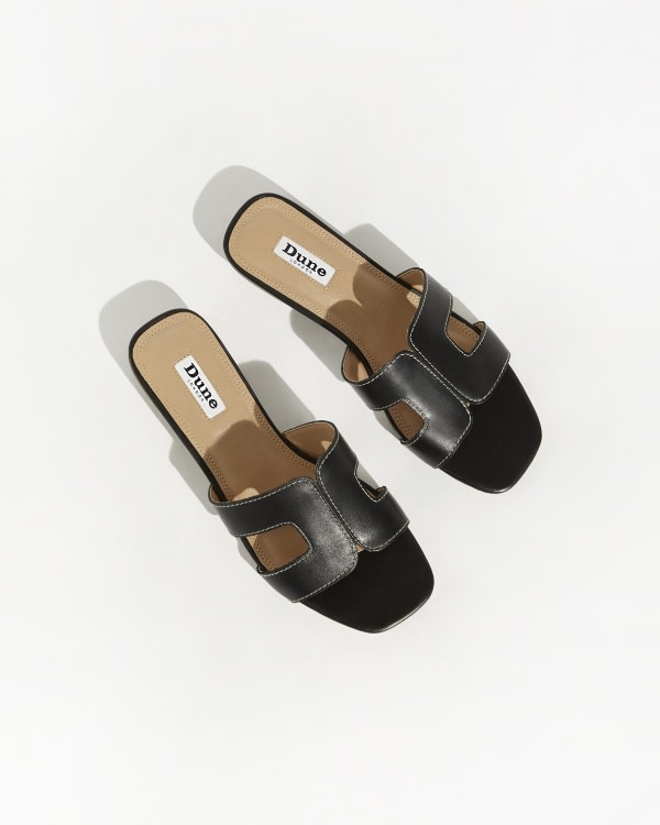 Black women’s Smart Slider Sandals crafted insoft locally sourced leather and features a cushioned sock and low heel.