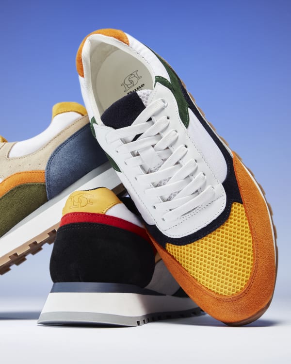 Men's trainer crafted from premium leather and suede in colour block panels