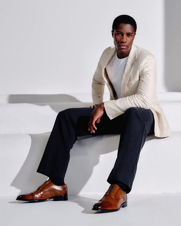 Model wearing Dune London men's brown formal shoes