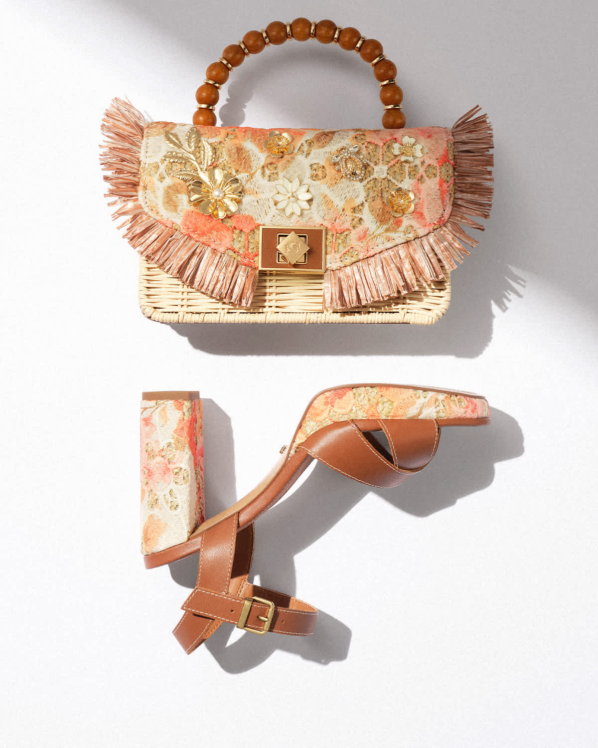 Matching heeled sandal and top handle bag with orange raffia design