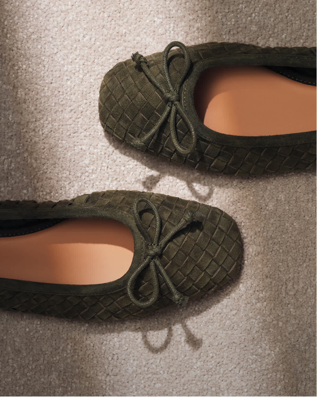An image of a pair of khaki ballet flats 