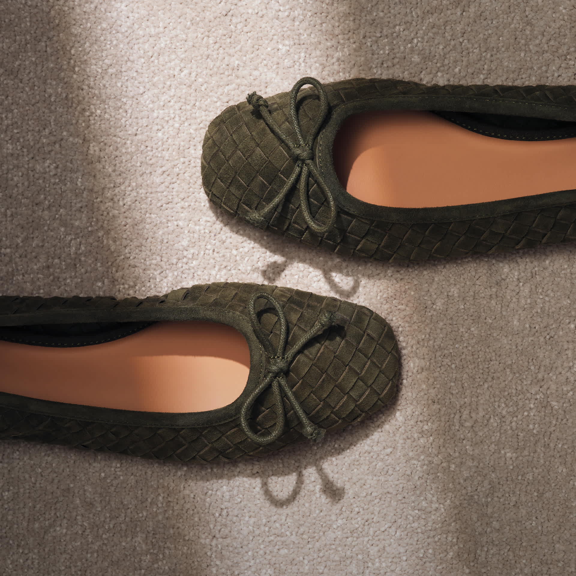 An image of a pair of khaki ballet flats 