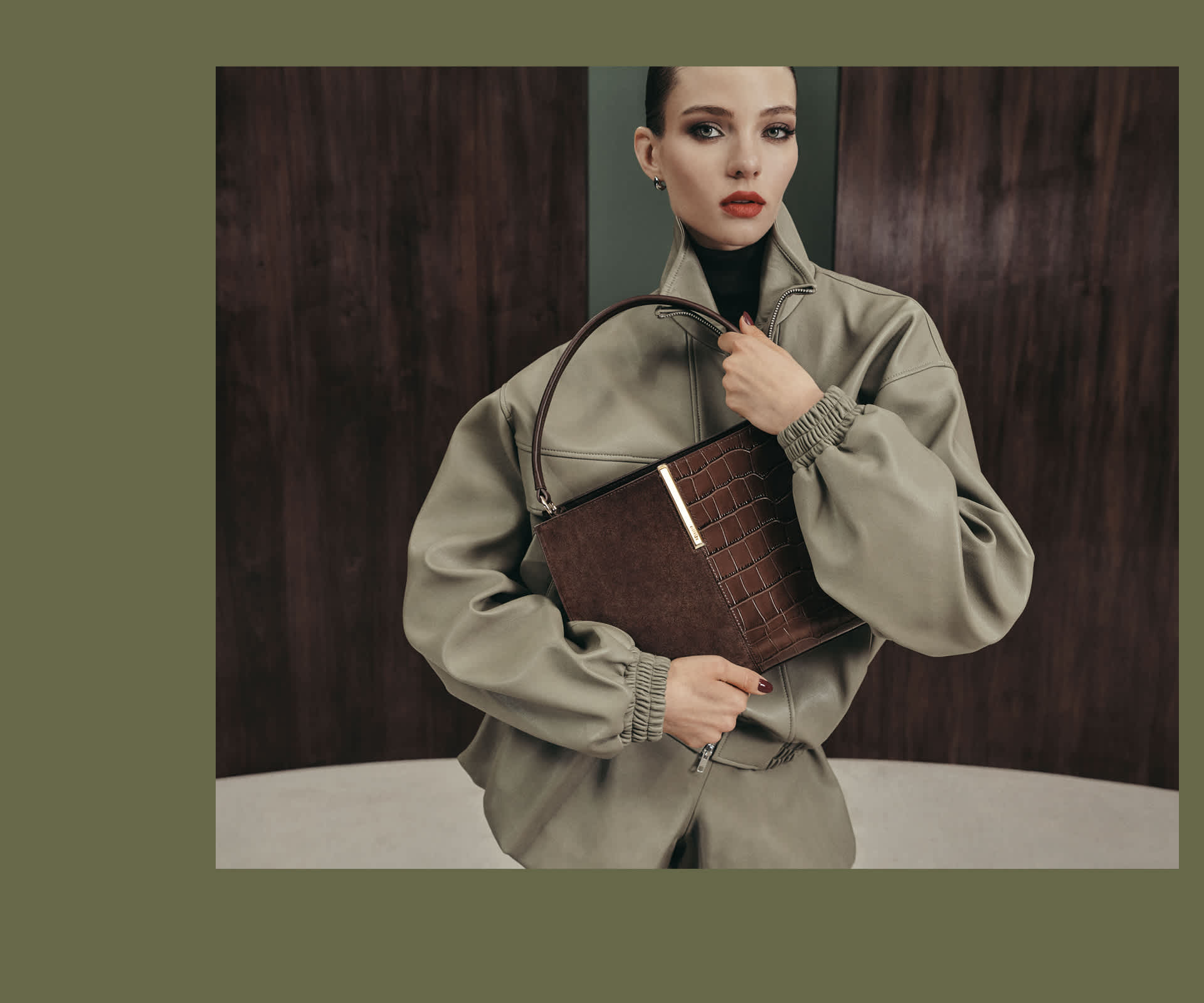 A woman holding a Dune london bag 