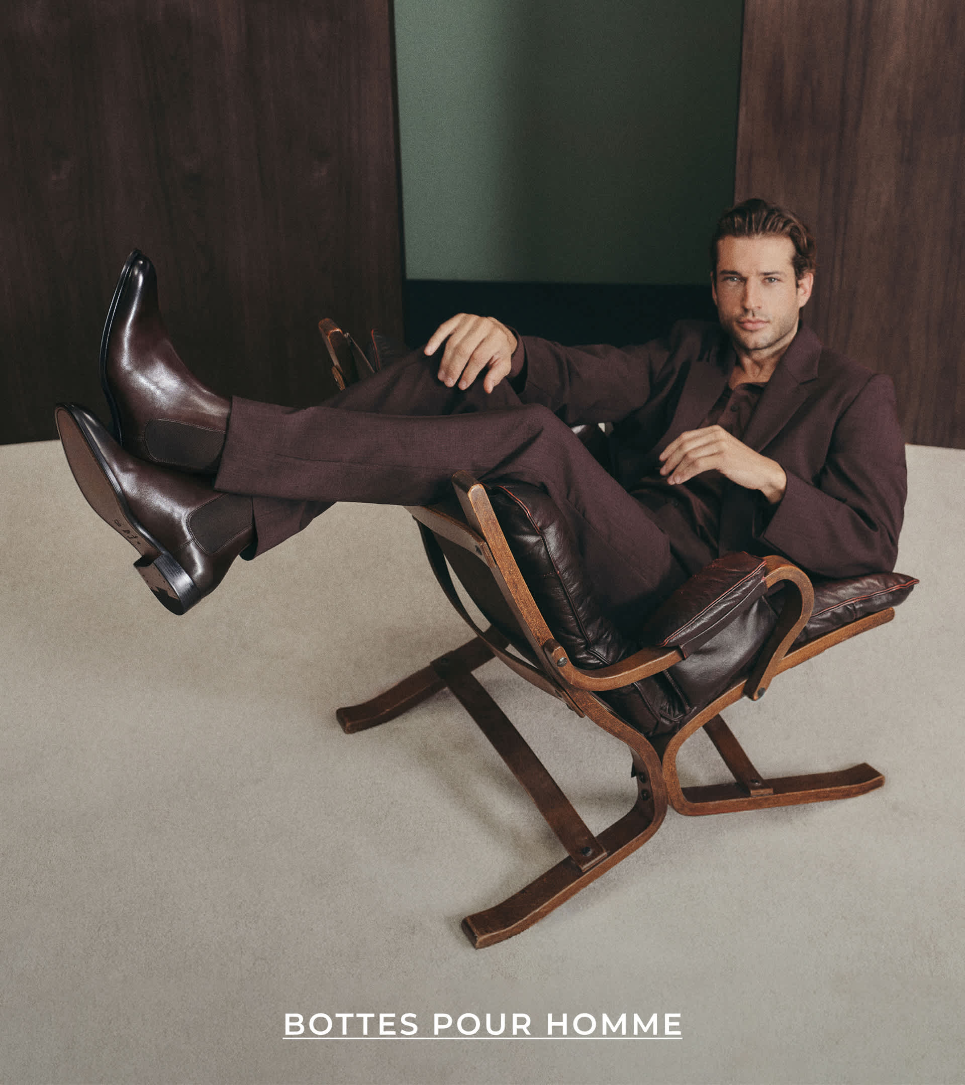 A man wearing formal boots sat on a chair 