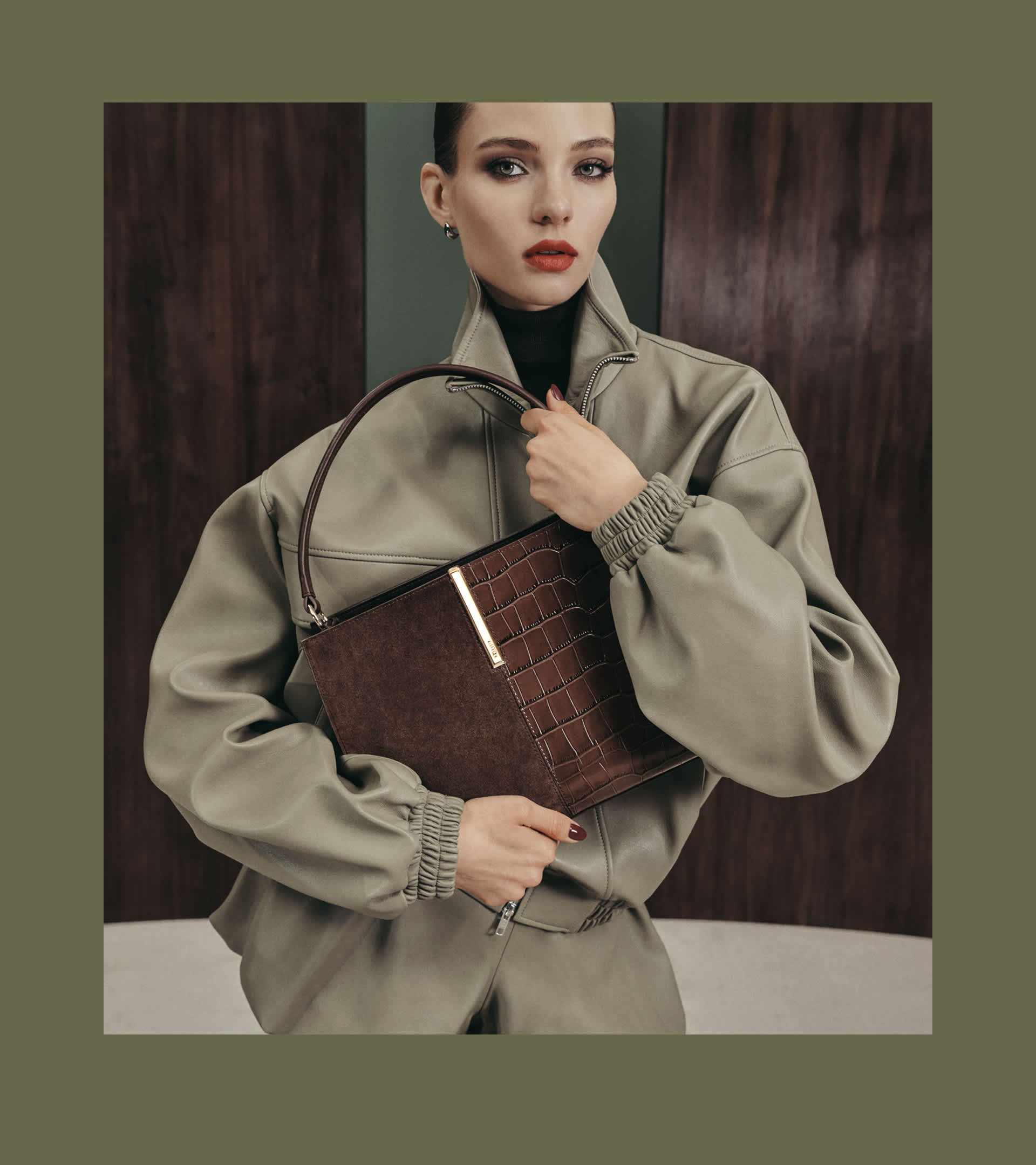 A woman holding a Dune london bag 