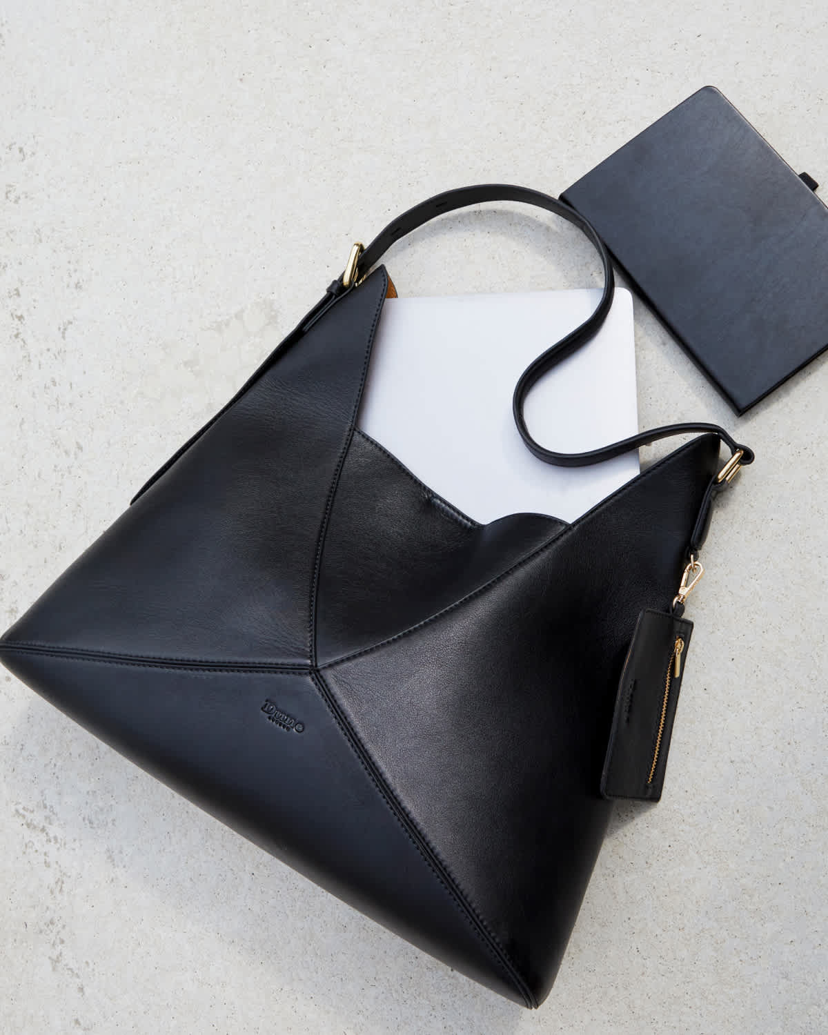 Black leather shoulder bag with laptop and notebook
