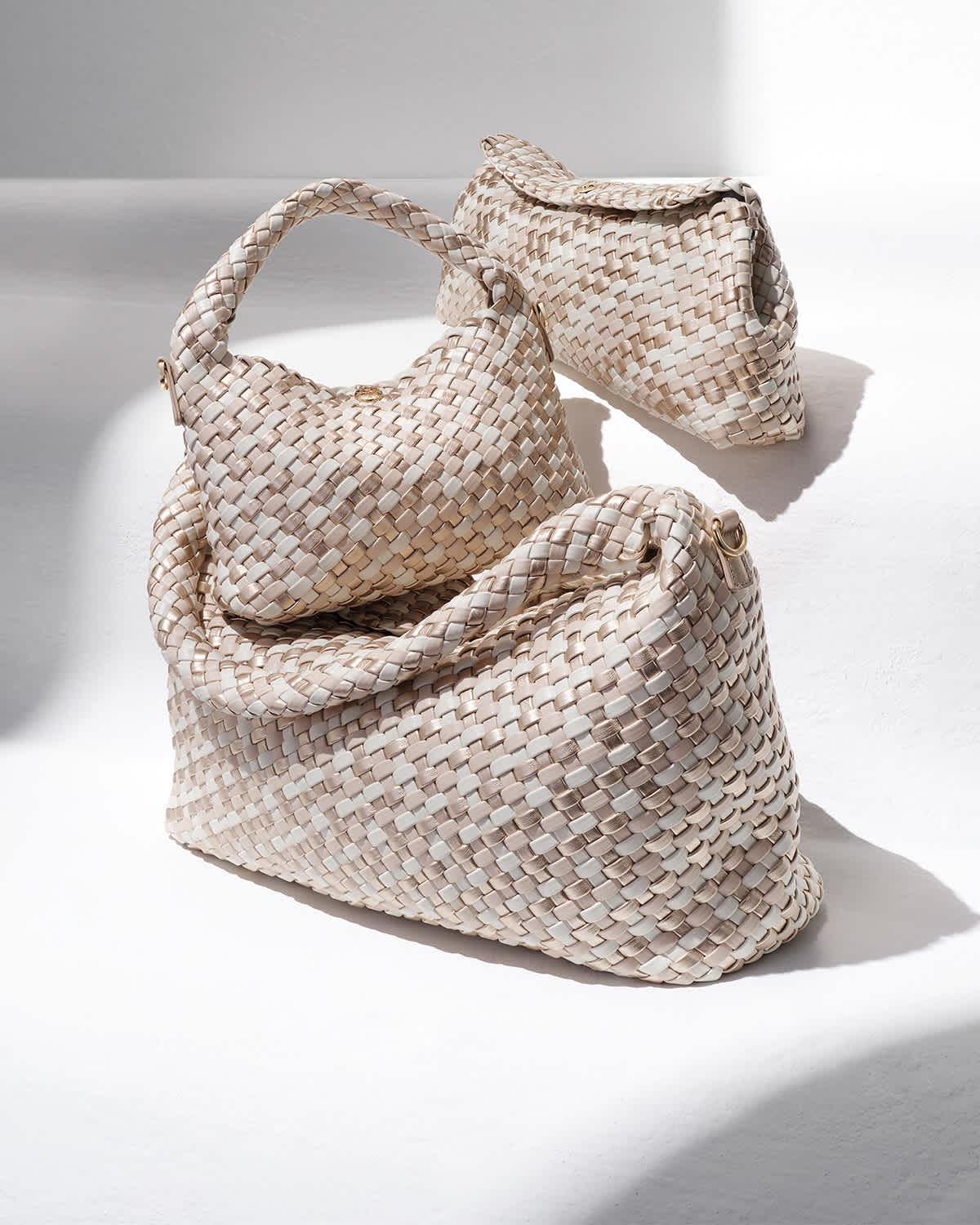 Women's woven Deliberate bags in ecru, large shoulder bag, dinky grab bag and clutch bag.