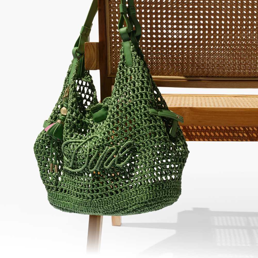 Dune Raffia logo bag on the back of a chair 