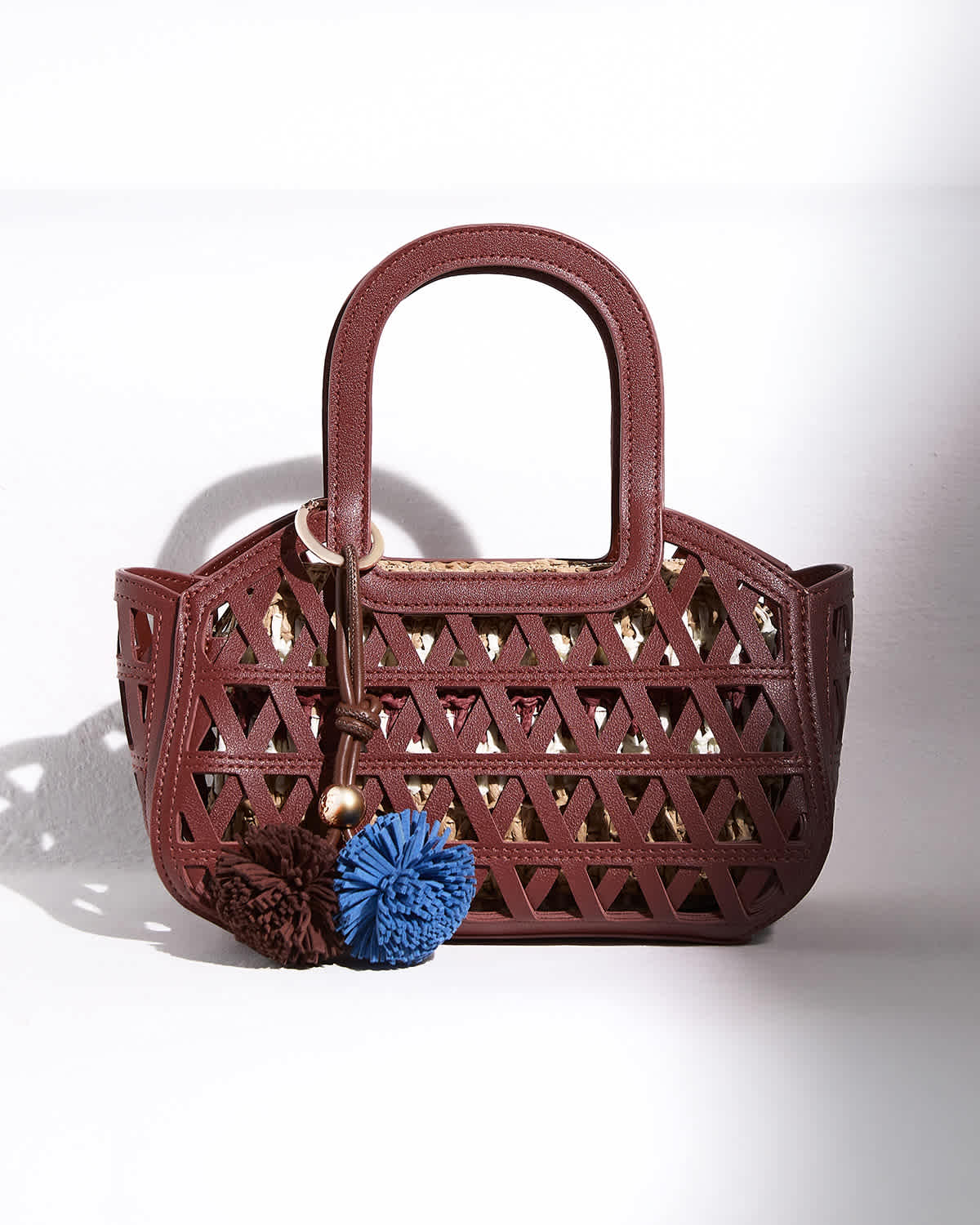 Dune Raffia logo bag on the back of a chair 