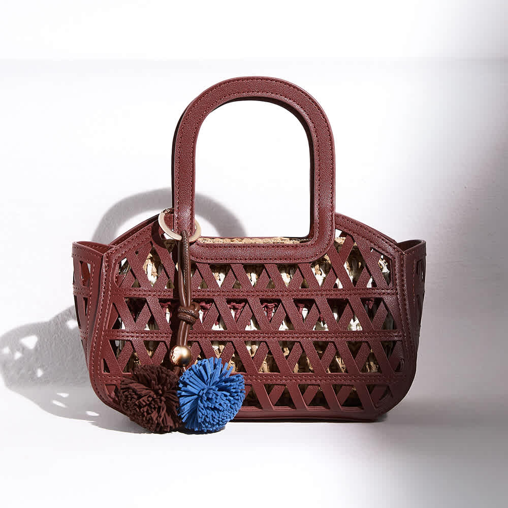 Dune Raffia logo bag on the back of a chair 