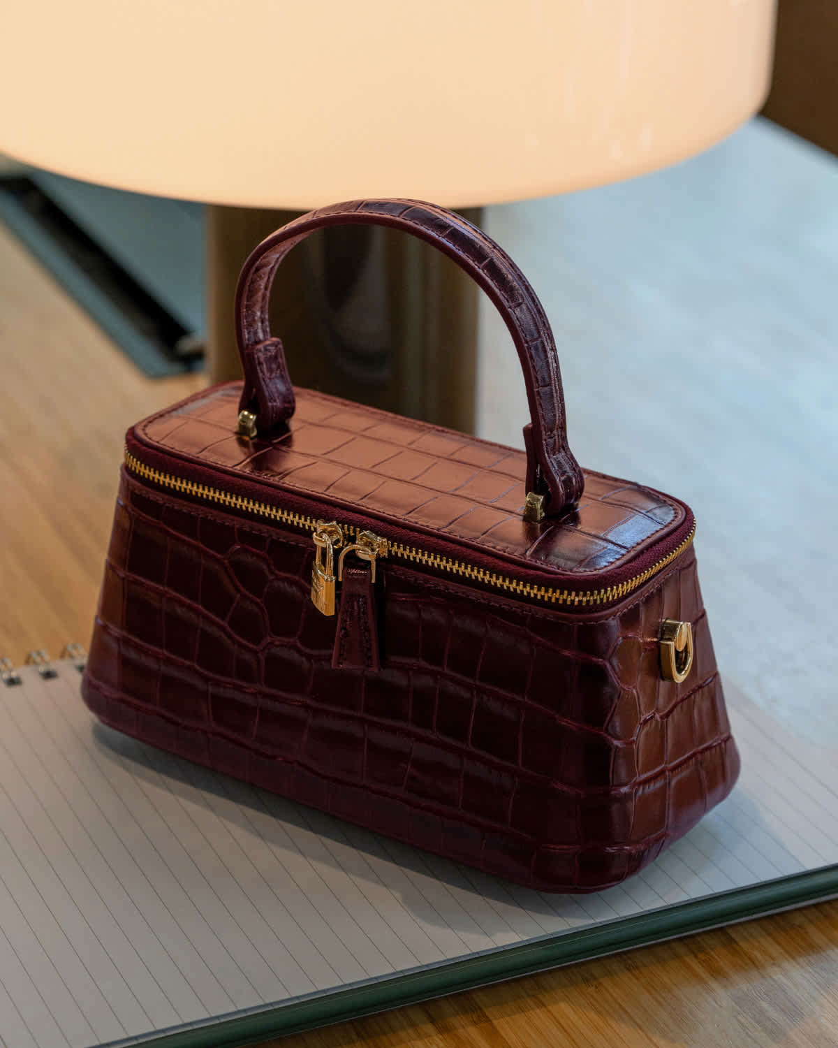 A burgundy Dune handbag on a table 