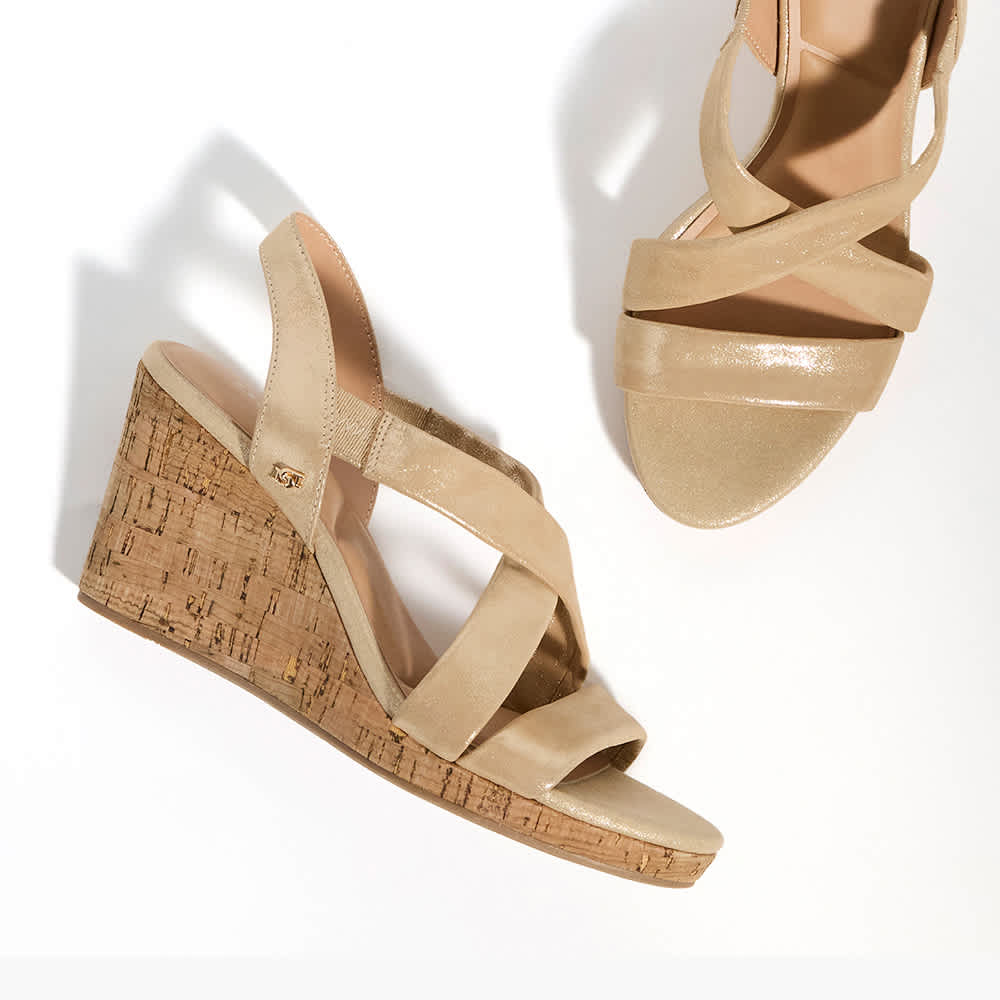 a pair of heeled sandals on a model 