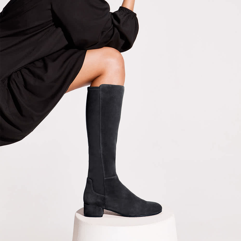 Woman wearing dark grey Stretch Knee-High Boots