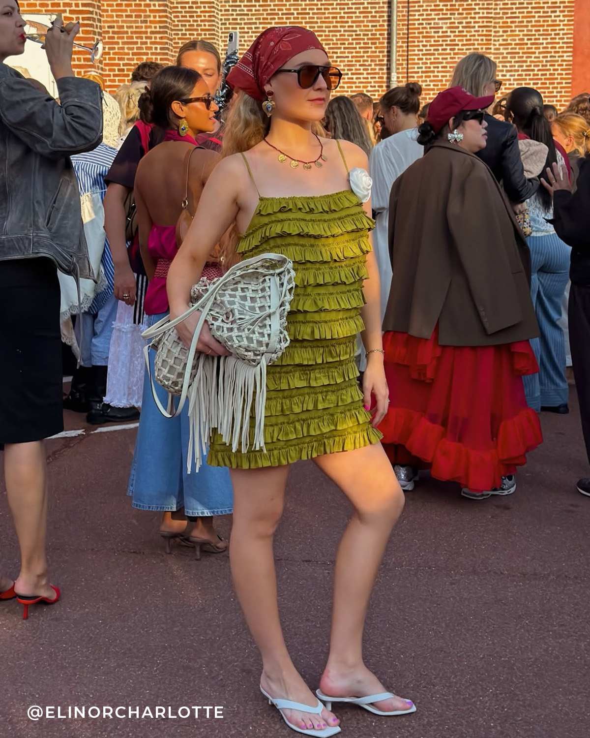 A woman wearing our Manic sandals in a crowd of people 