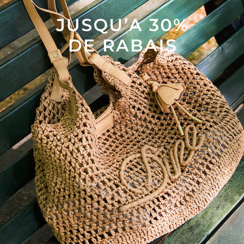 A model holding a Dune london handbag on her shoulder 