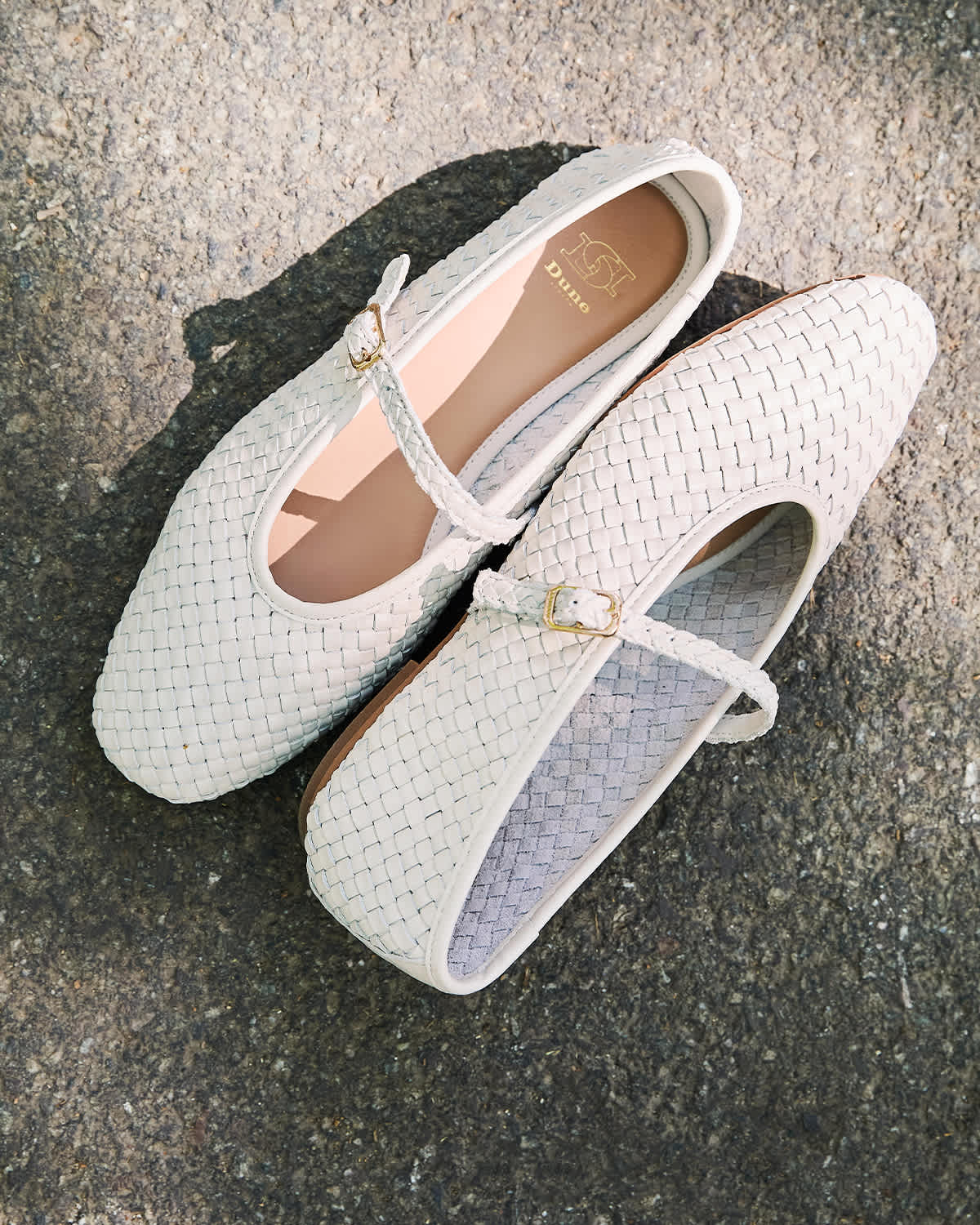 A pair of white women's flat woven flat shoes